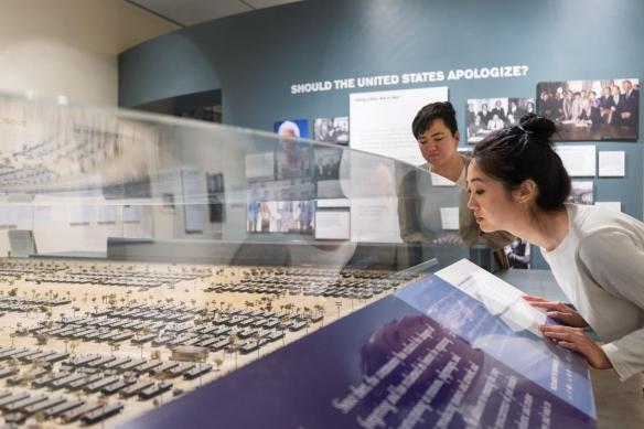 visitors looking at Manzanar diorama in Common Ground